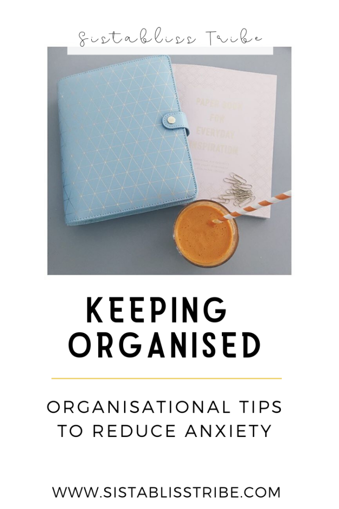Organisational Tips to Reduce Anxiety. Blue Kikki.K Wellness Planner and a glass of freshly squeezed fruit juice.