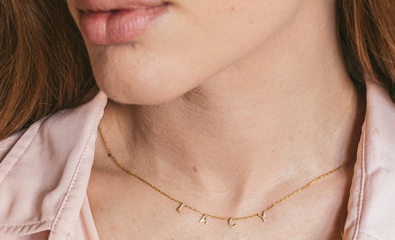 Lady wearing gold name necklace